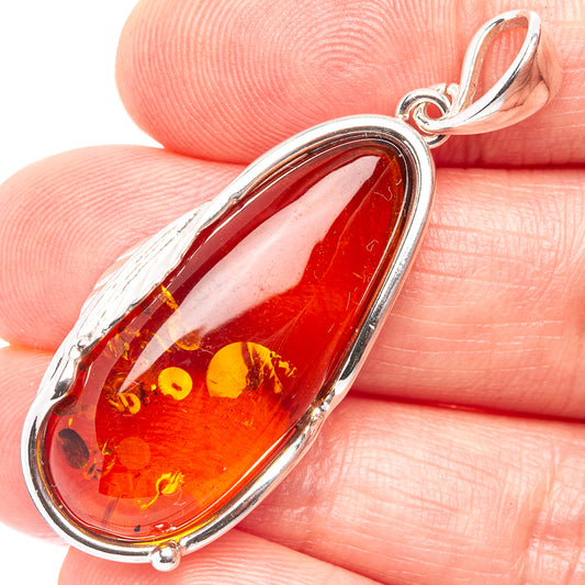 Teardrop Baltic amber pendant in .925 sterling silver with leaf-like inclusions