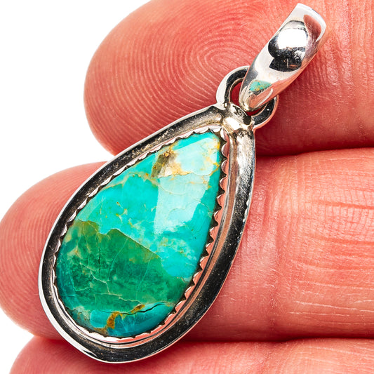 Sterling silver turquoise teardrop pendant close-up with textured bezel and bail