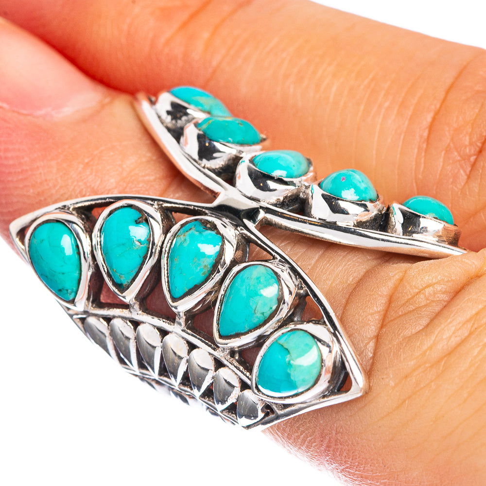 Turquoise teardrop gemstone silver ring with raised bezel and openwork side detail