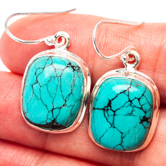 Sterling silver drop earrings with oval turquoise cabochon and small red top stones