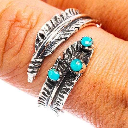 Turquoise cabochon feather cuff ring in sterling silver, close-up on finger