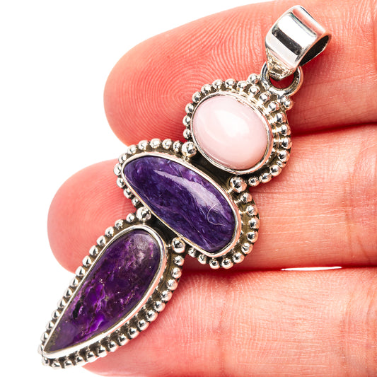 Sterling silver pendant with pink oval gemstone and two purple oval gemstones in bezel
