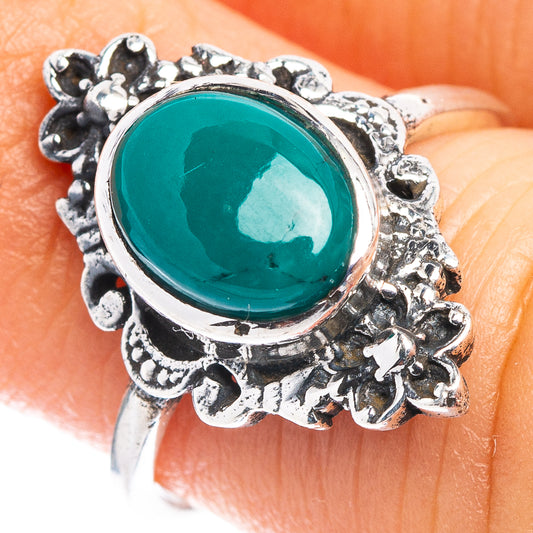 Sterling silver ring with oval green onyx centerpiece and floral filigree border