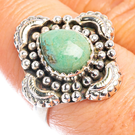 Sterling silver ring with oval green turquoise cabochon and ornate beadwork setting