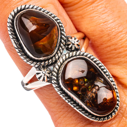Sterling silver fire agate oval ring on finger, dark top and amber-red bottom stone