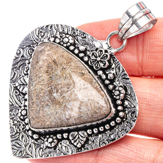 German silver coral pendant with ornate bezel and teardrop stone, loop bail