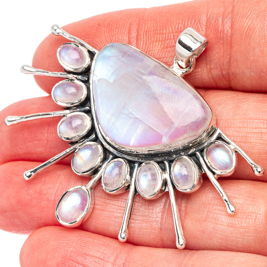 Sterling silver rainbow moonstone pendant with teardrop opalescent center and oval cluster rays