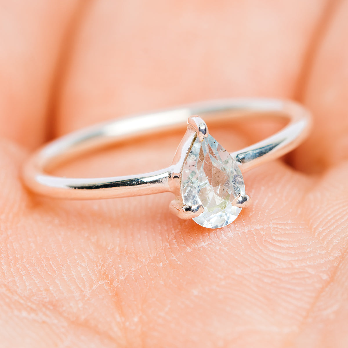 Stackable 925 sterling silver ring with blue topaz teardrop stone and slim band