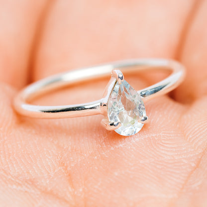 Stackable 925 sterling silver ring with blue topaz teardrop stone and slim band