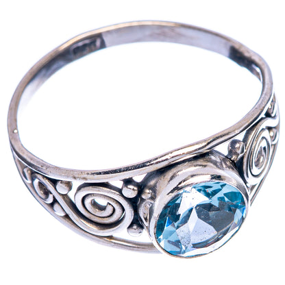 Sterling silver dainty ring with blue topaz and ornate swirl settings