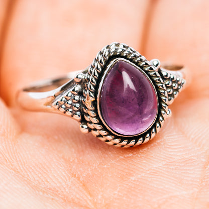 Side view oval amethyst cabochon sterling silver ring with scalloped bezel and texture