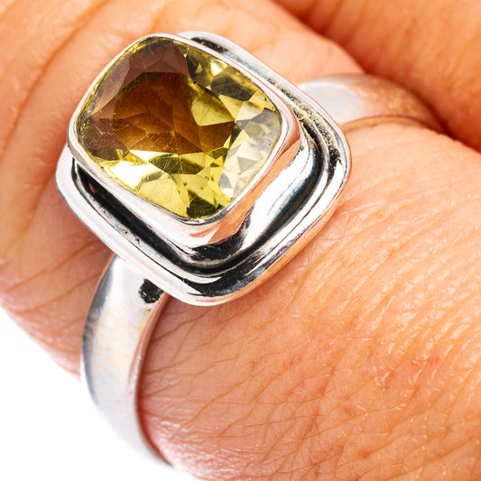 Sterling silver ring with faceted lemon quartz center stone, square prong setting.