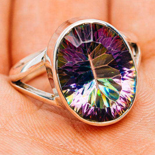 Sterling silver ring featuring oval rainbow mystic topaz gemstone in faceted bezel