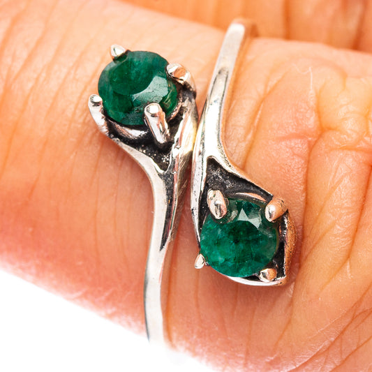Sterling silver ring with two green gemstones, prong-set, open curved band
