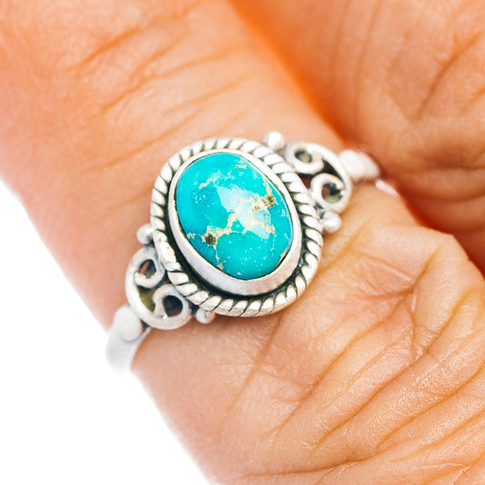Turquoise oval sterling silver ring with rope-edge bezel and ornate side cutouts