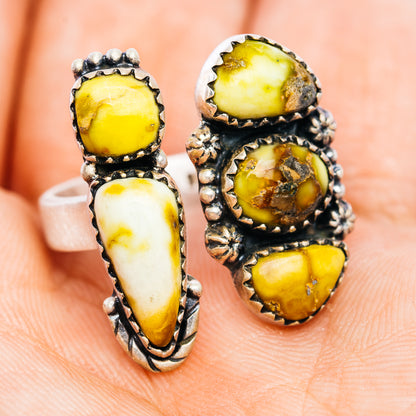 Silver openwork ring with stacked oval yellow and white stones, ornate side settings