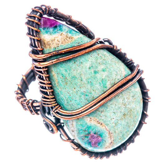 Oxidized copper wire ring showing stacked metal bands and oval green stone with purple