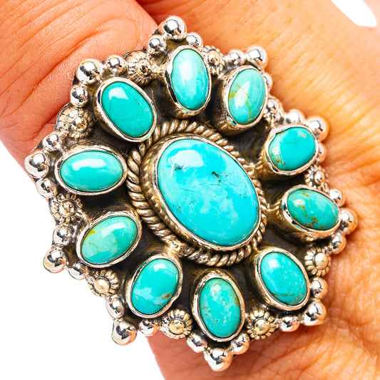 Turquoise oval-stone statement ring on finger, detailed silver border and prongs