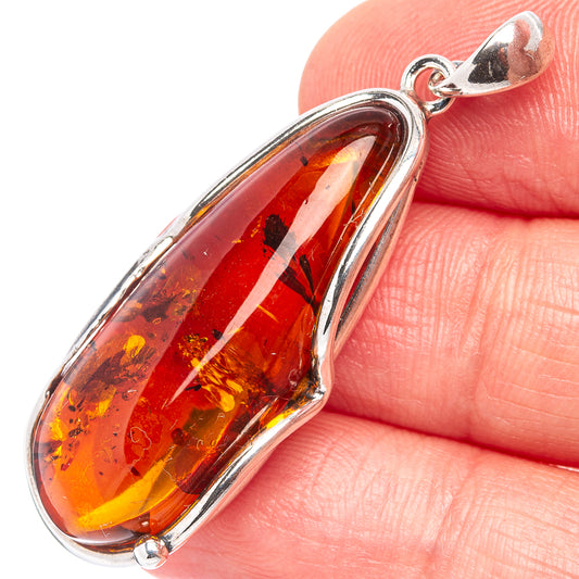 Amber teardrop pendant with .925 sterling silver frame and bail loop.