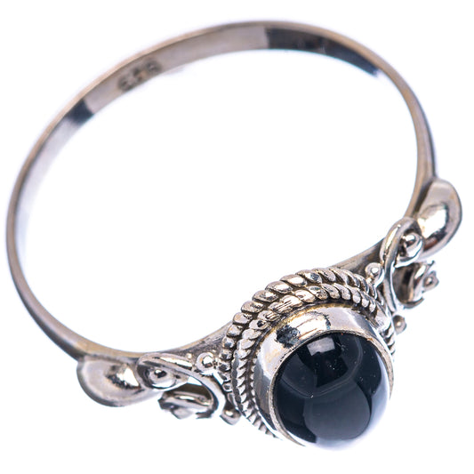 Sterling silver onyx ring with openwork prongs and oval dark stone, side view