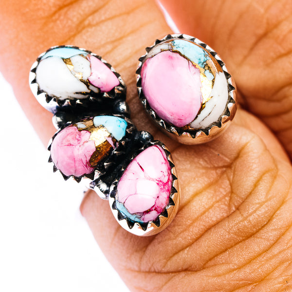 Southwestern silver ring with four oval pink stones, turquoise accents, serrated bezels