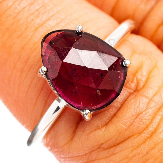 Faceted garnet ring in .925 sterling silver with oval maroon gemstone, four-prong setting
