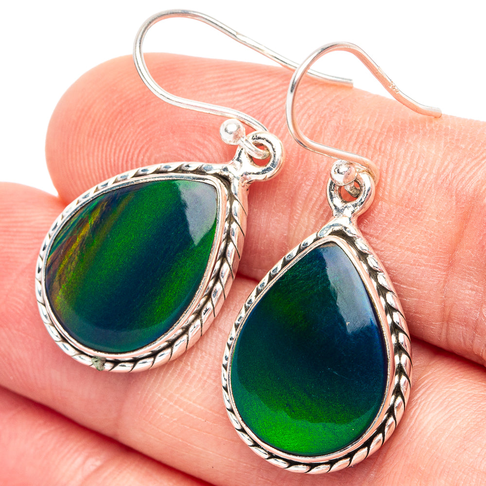 Sterling silver teardrop earrings with green opal-style centers on curved hooks