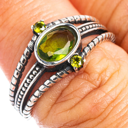 Sterling silver peridot ring with oval green gemstone and small accent stones
