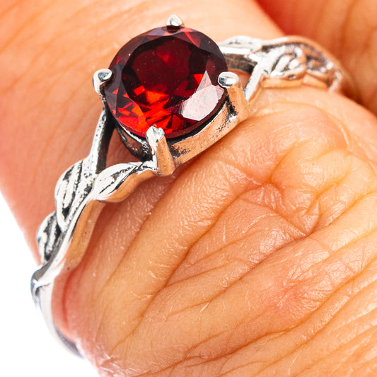 Dainty garnet ring with round red gemstone and sterling silver leaf setting