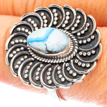 Turquoise oval cabochon sterling silver ring with ornate blackened scrollwork.