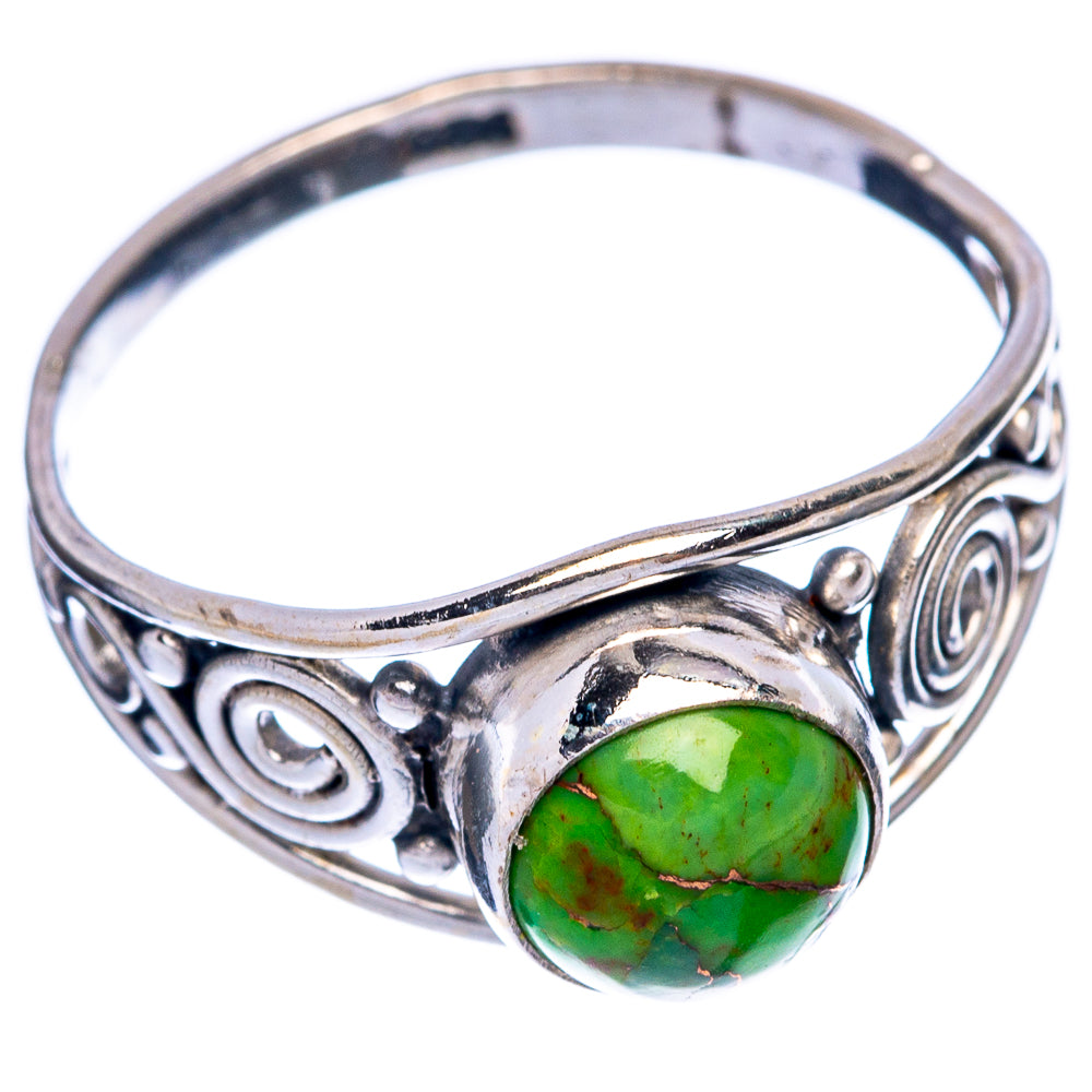 Sterling silver ring with green oval turquoise cabochon and ornate swirl side settings