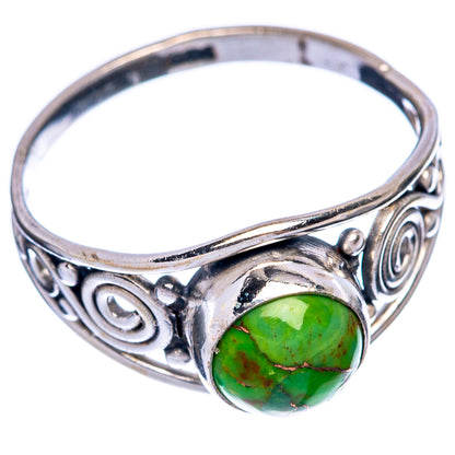 Sterling silver ring with green oval turquoise cabochon and ornate swirl side settings