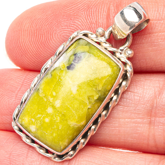 Rectangular lizardite pendant in .925 sterling silver bezel, yellow-green stone with textured frame.