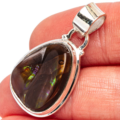 Sterling silver fire agate pendant, close-up oval dark stone with colorful rainbow fire