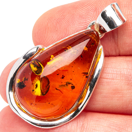 Amber teardrop pendant with .925 sterling silver frame and clear amber inclusion detail