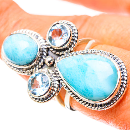 Silver ring with oval turquoise larimar stones and round blue gemstones, ornate setting