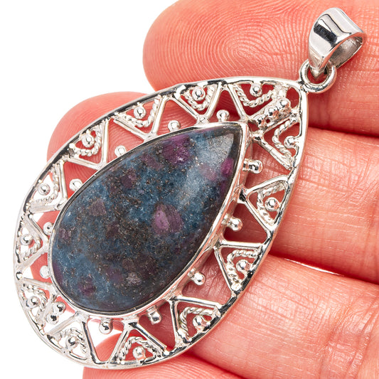Sterling silver gemstone pendant with oval filigree bezel and blue-purple stone