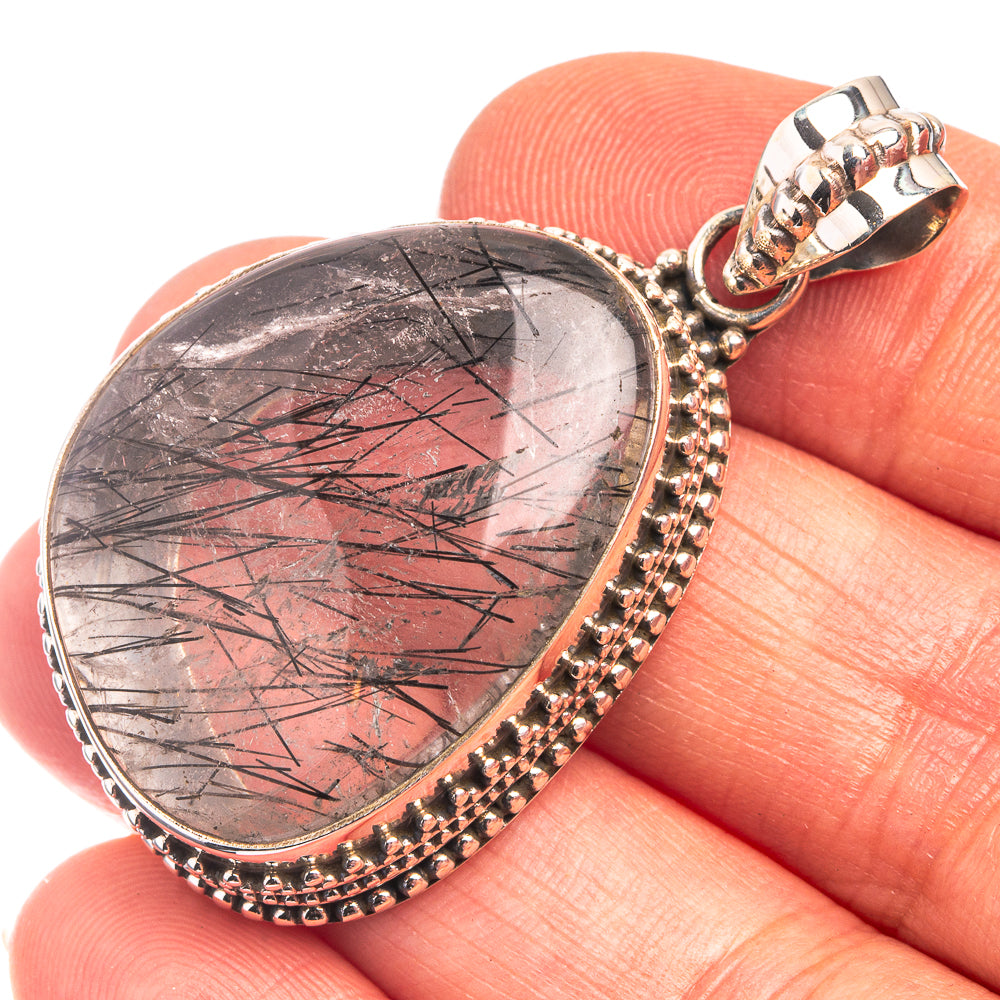 Heart-shaped tourmalinated quartz pendant in silver bezel with bead border