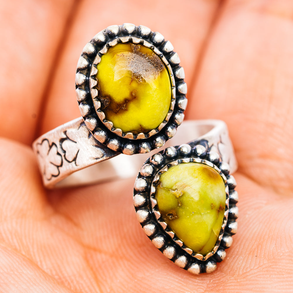 Adjustable sterling silver ring with two oval yellow gemstones and etched band