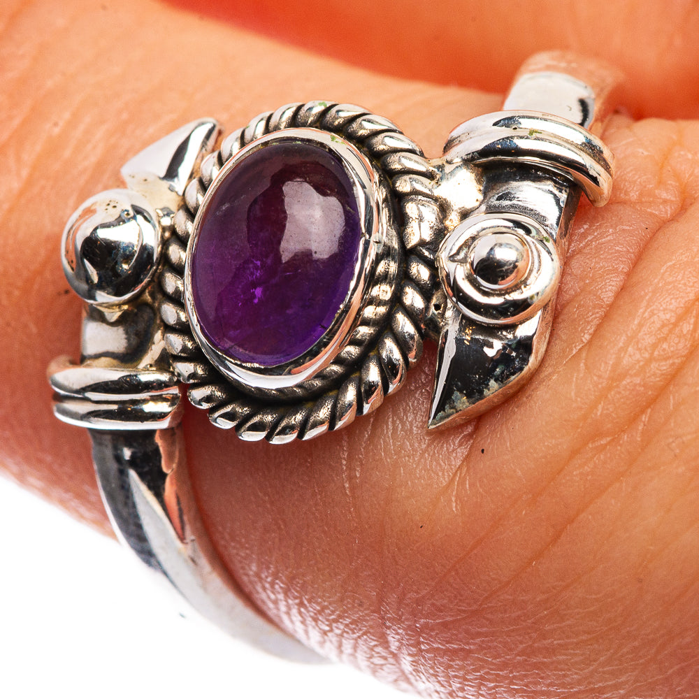 Dainty sterling silver ring with oval amethyst purple gemstone and ornate scrollwork