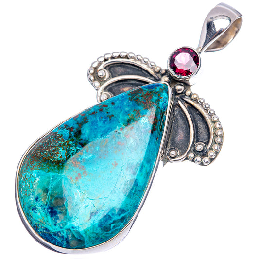 Turquoise teardrop pendant with ornate silver bezel and red garnet top loop bail.