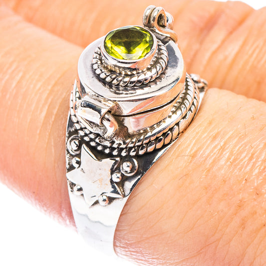 Sterling silver peridot poison ring with round green gemstone and ornate rope setting