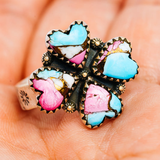 Heart-shaped stone cluster ring with turquoise and pink inlays on dark silver band