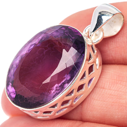 Oval faceted amethyst pendant in sterling silver with cutout side frame and bail
