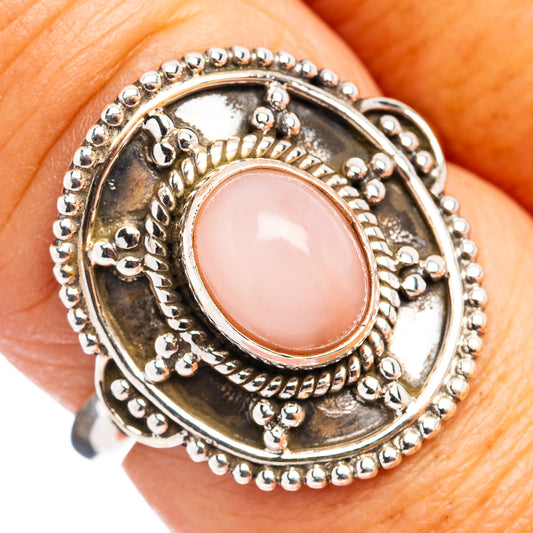 Sterling silver ring with pink oval cabochon and detailed beaded halo setting