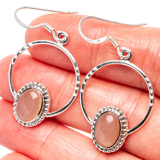 Peach moonstone hoop earrings in .925 sterling silver, oval stone with beaded halo