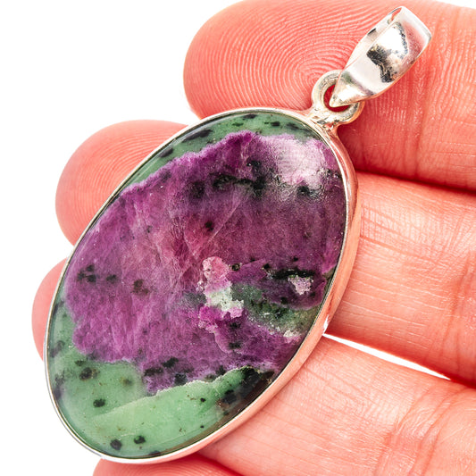 Oval purple-green stone pendant in .925 sterling silver bezel, bail at top