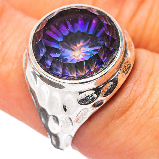 Sterling silver ring with large dark purple-blue gemstone in scalloped bezel