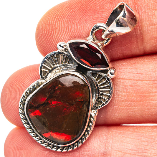 Sterling silver pendant with oval red Canadian ammolite and garnet-like bezel stones