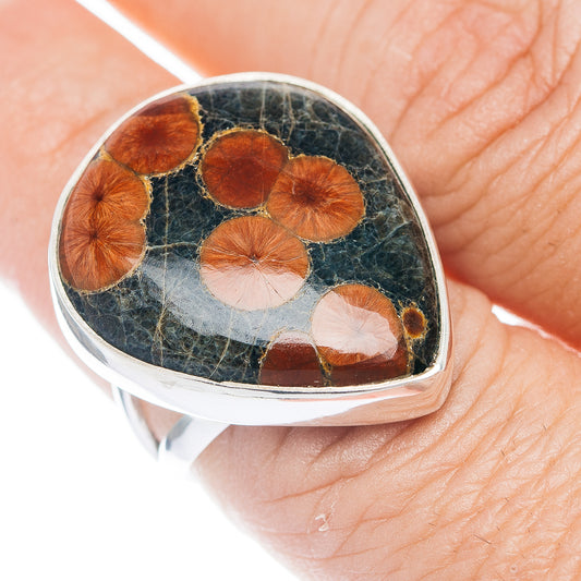 Sterling silver teardrop ring with dark stone cabochon and orange-red inclusions